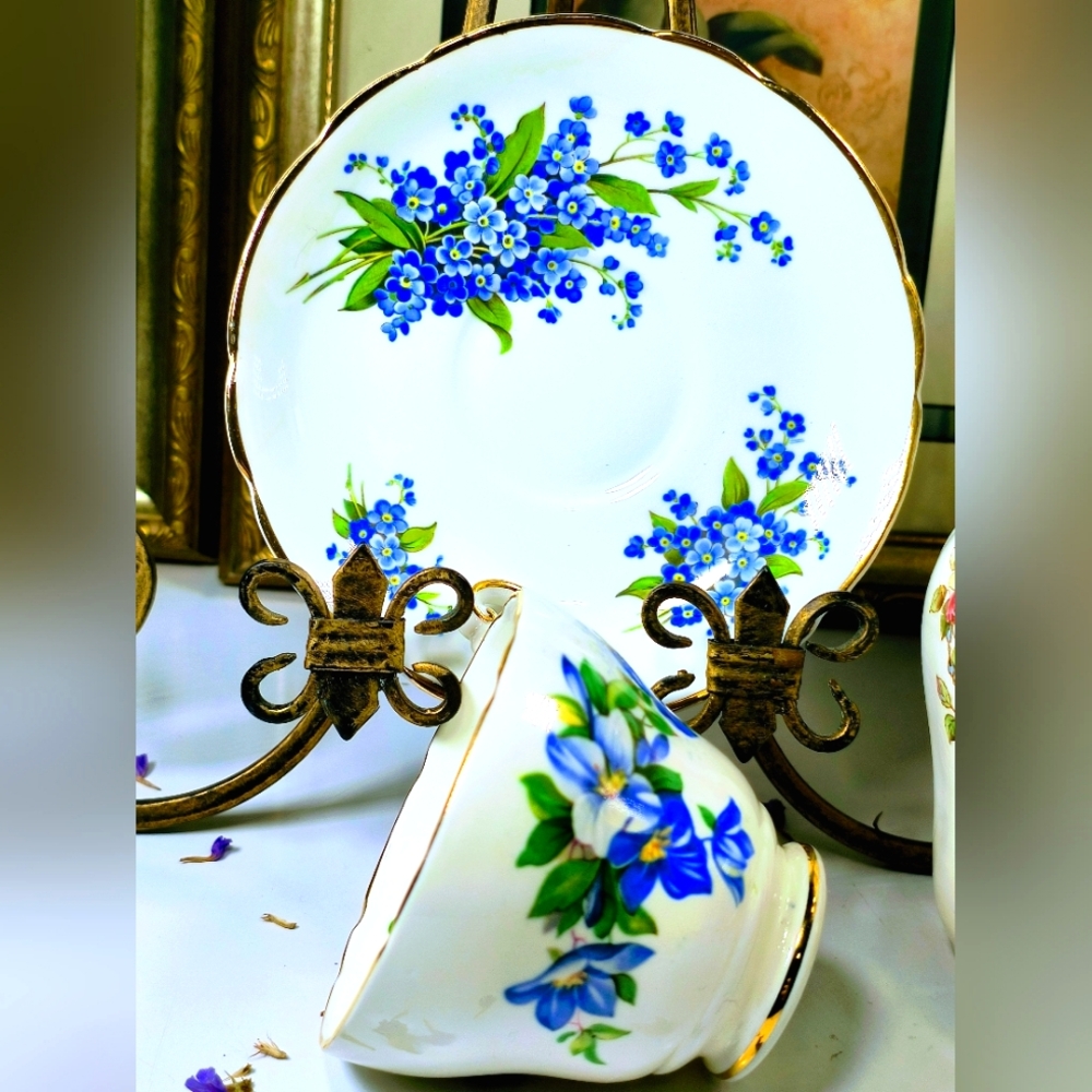 Charming teacup and saucer with blue floral design. Elegant gold accents. Perfec
